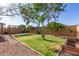 Relaxing backyard with lush green grass and mature landscaping at 15814 W Adams St, Goodyear, AZ 85338