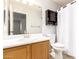 Functional bathroom featuring a vanity, toilet, mirror, and shower with a curtain for privacy at 15814 W Adams St, Goodyear, AZ 85338