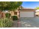 Charming single-story home with a two-car garage and well-manicured landscaping at 15814 W Adams St, Goodyear, AZ 85338