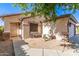 Charming home facade with a quaint seating area and convenient walkway to front door at 15814 W Adams St, Goodyear, AZ 85338