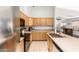 Bright kitchen with stainless-steel appliances and wood cabinetry, perfect for cooking and entertaining at 15814 W Adams St, Goodyear, AZ 85338