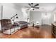 Spacious living room with hardwood floors, a ceiling fan, and modern decor at 15814 W Adams St, Goodyear, AZ 85338