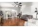 Open concept living space with hardwood floors and a view to the dining area at 15814 W Adams St, Goodyear, AZ 85338