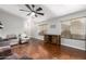 Bright living room featuring hardwood floors and ample natural light from large windows at 15814 W Adams St, Goodyear, AZ 85338