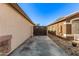 Spacious side yard featuring a secure wooden gate, concrete patio, and low-maintenance gravel landscaping at 15814 W Adams St, Goodyear, AZ 85338