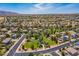 Expansive aerial view of a suburban community featuring homes, parks, and mountain views on a sunny day at 16333 N 181St Ave, Surprise, AZ 85388