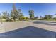 Outdoor basketball court with well-maintained concrete surface, hoops, and surrounding trees on a clear day at 16333 N 181St Ave, Surprise, AZ 85388