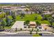 Aerial view of a neighborhood park featuring a basketball court, picnic area, playground, and volleyball court for community enjoyment at 16333 N 181St Ave, Surprise, AZ 85388