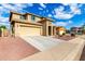 Inviting stucco home with a two-car garage, wide driveway, and colorful drought tolerant landscaping at 16333 N 181St Ave, Surprise, AZ 85388