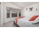 A cozy bedroom featuring a large window bay, comfortable bed, and decorative wall art at 2263 N Trekell Rd # 20, Casa Grande, AZ 85122