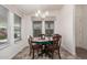 Cozy dining area featuring a wooden table with chairs, a chandelier, and natural light from multiple windows at 2263 N Trekell Rd # 20, Casa Grande, AZ 85122