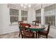 Bright dining area featuring a wooden table with four chairs with lots of natural light from large windows at 2263 N Trekell Rd # 20, Casa Grande, AZ 85122