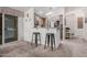 Open-concept kitchen with a breakfast bar featuring stylish stools and seamless connection to the living area at 2263 N Trekell Rd # 20, Casa Grande, AZ 85122