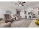 Comfortable living room with plush seating, a ceiling fan, and an open view into the adjacent kitchen at 2263 N Trekell Rd # 20, Casa Grande, AZ 85122