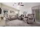 Bright living room with comfortable seating, a ceiling fan, and natural light from windows with stylish curtains at 2263 N Trekell Rd # 20, Casa Grande, AZ 85122