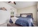 Comfortable main bedroom with a wooden bed frame, lots of pillows, a ceiling fan, and carpeted floors at 2263 N Trekell Rd # 20, Casa Grande, AZ 85122
