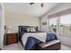 Cozy main bedroom with a dark wood bed frame, a bedside table, and large windows with white trim at 2263 N Trekell Rd # 20, Casa Grande, AZ 85122