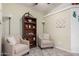 Quiet sitting area featuring comfortable armchairs, a bookshelf, and ample lighting for reading and relaxation at 2263 N Trekell Rd # 20, Casa Grande, AZ 85122