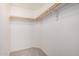 A neutral walk-in closet design featuring installed wooden clothing racks, carpeted floors, and white walls at 2263 N Trekell Rd # 20, Casa Grande, AZ 85122
