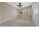 Bedroom featuring carpet, ceiling fan, window, and closet at 28770 N 69Th Ln, Peoria, AZ 85383
