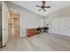 Bedroom featuring hardwood floors, ceiling fan, closet, and desk at 28770 N 69Th Ln, Peoria, AZ 85383