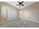 Bedroom with carpet, ceiling fan, and closet at 28770 N 69Th Ln, Peoria, AZ 85383