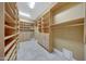Walk-in closet features adjustable wood shelving and drawers at 28770 N 69Th Ln, Peoria, AZ 85383