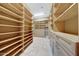 Walk-in closet with wood shelving and drawers for optimal storage at 28770 N 69Th Ln, Peoria, AZ 85383
