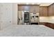 Close-up of kitchen appliances and a white granite counter top at 28770 N 69Th Ln, Peoria, AZ 85383