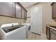 Well-equipped laundry room featuring modern appliances and ample cabinet space at 28770 N 69Th Ln, Peoria, AZ 85383