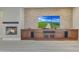 Living room with stone fireplace and built-in entertainment center at 28770 N 69Th Ln, Peoria, AZ 85383