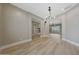 Open-concept living room with wood floors and access to other rooms at 28770 N 69Th Ln, Peoria, AZ 85383