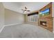 Main bedroom boasts fireplace, TV, carpet, and plantation shutters at 28770 N 69Th Ln, Peoria, AZ 85383