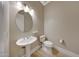 Charming powder room with pedestal sink and modern fixtures at 28770 N 69Th Ln, Peoria, AZ 85383