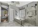 Bright bathroom featuring a soaking tub and a glass-enclosed shower with stylish tile and modern fixtures at 6264 E Omega St, Mesa, AZ 85215