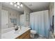 Neutral bathroom featuring a modern vanity, commode, and a shower with a blue ombre curtain at 6264 E Omega St, Mesa, AZ 85215