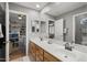 Bathroom featuring double sinks, natural wood cabinets and mirror, offering multiple views of the home at 6264 E Omega St, Mesa, AZ 85215