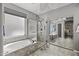 Relaxing primary bathroom featuring a soaking tub, walk-in shower, and sliding mirror doors at 6264 E Omega St, Mesa, AZ 85215