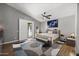 Spacious bedroom boasts vaulted ceilings, gray walls, a modern fan, and access to the backyard patio at 6264 E Omega St, Mesa, AZ 85215