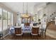 An elegant dining room is illuminated by a modern chandelier over a dining table at 6264 E Omega St, Mesa, AZ 85215