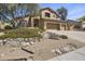Beautiful two-story home with a three-car garage and professionally landscaped front yard at 6264 E Omega St, Mesa, AZ 85215