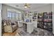 Bright home office with custom shelving, comfortable chair, and plenty of natural light at 6264 E Omega St, Mesa, AZ 85215