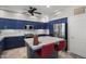 Modern kitchen with blue cabinets, a center island, and stainless steel appliances at 6264 E Omega St, Mesa, AZ 85215
