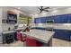 Bright kitchen features blue cabinets, stainless appliances, and a marble island perfect for gathering and entertaining at 6264 E Omega St, Mesa, AZ 85215