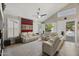 Bright living room boasts vaulted ceilings, plantation shutters, and a view of the outdoor swimming pool at 6264 E Omega St, Mesa, AZ 85215