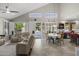 A spacious living room with an airy vaulted ceiling connects seamlessly to the outdoor pool area at 6264 E Omega St, Mesa, AZ 85215