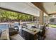 Inviting outdoor living area with comfortable seating, fire pit, and serene pool views at 6264 E Omega St, Mesa, AZ 85215