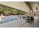 Covered outdoor patio area boasts a built-in grill and dining area with a view of the sparkling pool at 6264 E Omega St, Mesa, AZ 85215