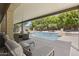 Relaxing poolside lounge area featuring comfortable seating and a view of the sparkling pool at 6264 E Omega St, Mesa, AZ 85215