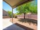 Relaxing covered patio in a private backyard with desert landscaping at 6942 S Championship Dr, Chandler, AZ 85249